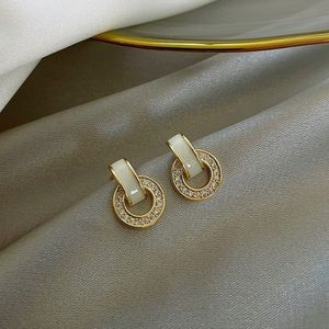 Round gold earring with rhinestone